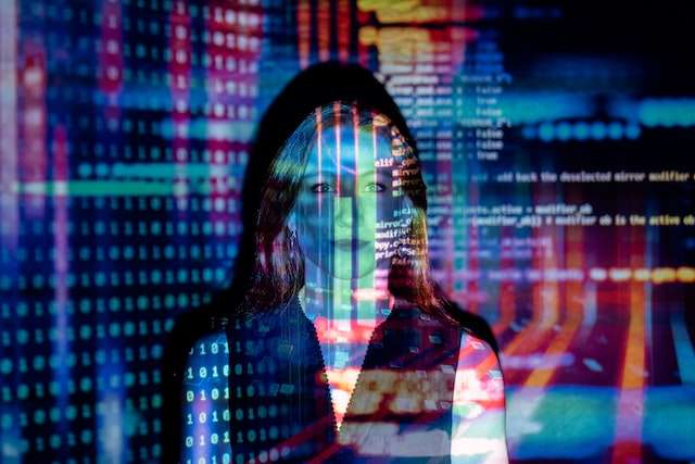 A woman with computer code projected on our face, symbolic of our bookkeeping sofware services.