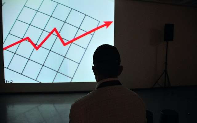 A man looking at a chart, symbolic of our monthly bookkeeping services including financial statement preparation.