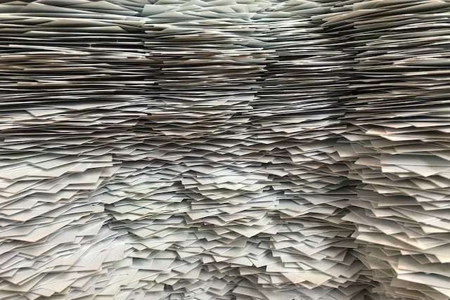A huge pile pf paper, symbolic of eCommerce AR and AP services.