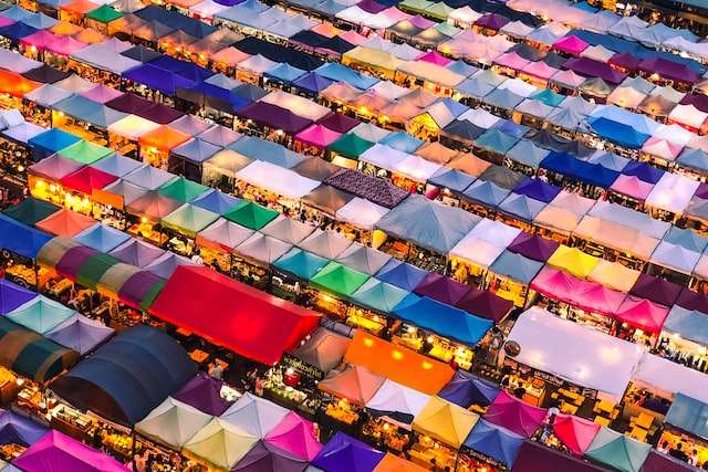 Hundreds of brightly colored tents at a market, symbolic of eCommerce bookkeeping for Facebook Marketplace.